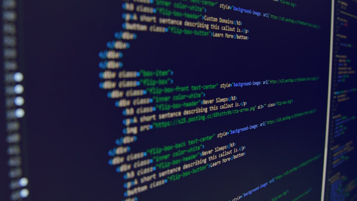 Lines of web code on a dark computer screen