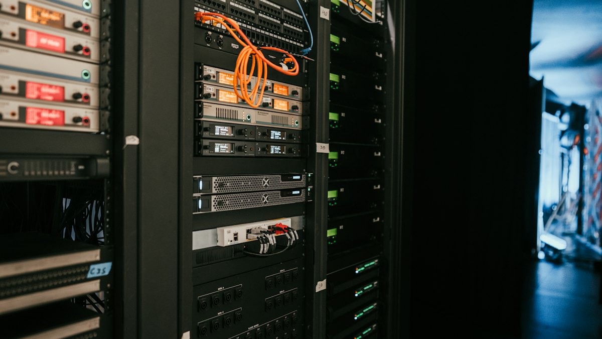 Racks of servers and network equipment in a dark server room