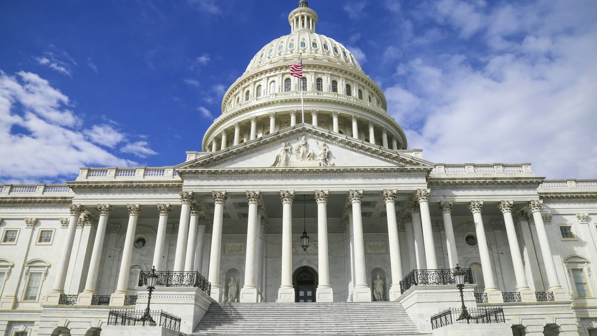 The US Capitol building under a blue sky